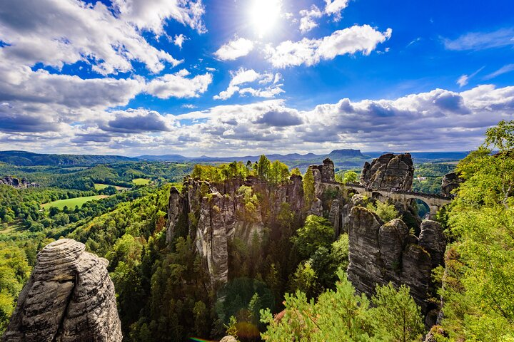 Discover stunning rock formations and lush greenery while exploring the breathtaking views from Bastei Bridge. Experience the natural beauty and rich history of Bohemian and Saxon Switzerland.
